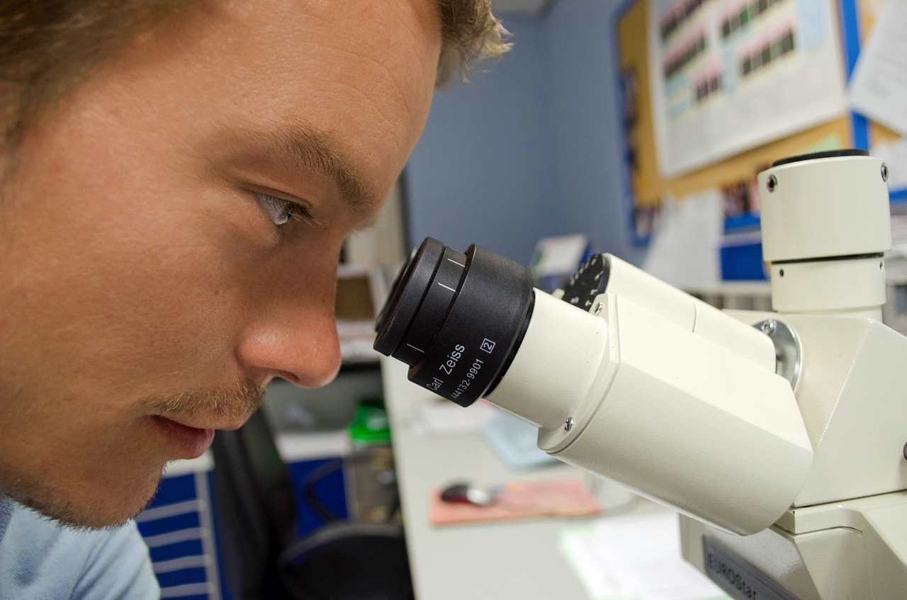 Person looking through microscope