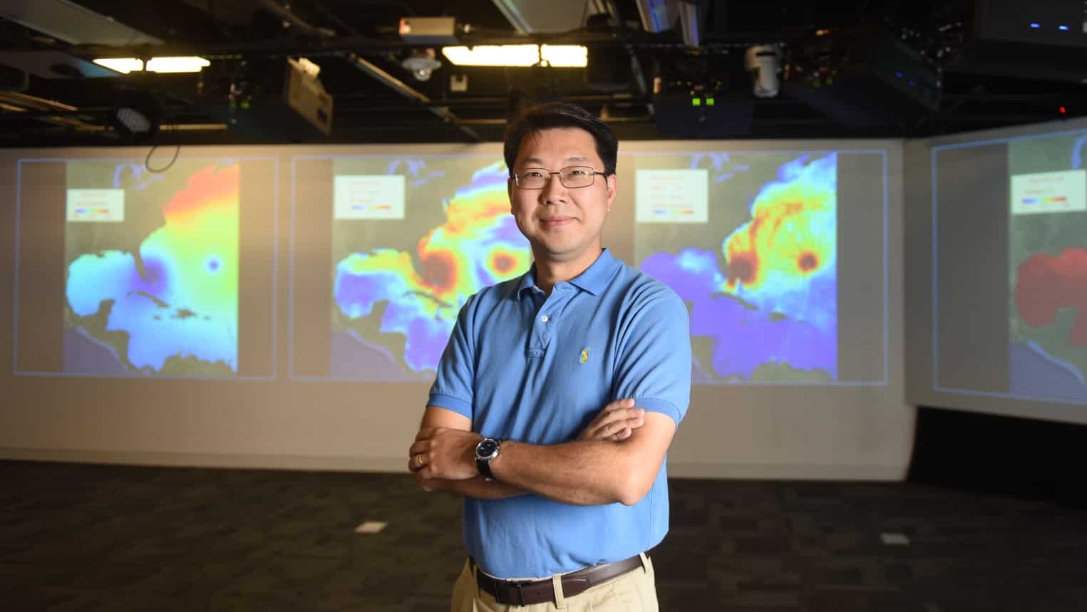 Researcher standing in front of map technology