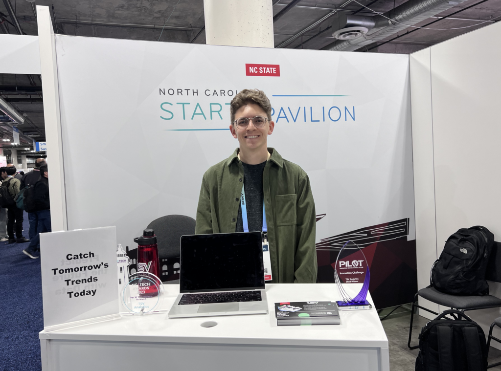 Startup founder standing in booth on trade show floor