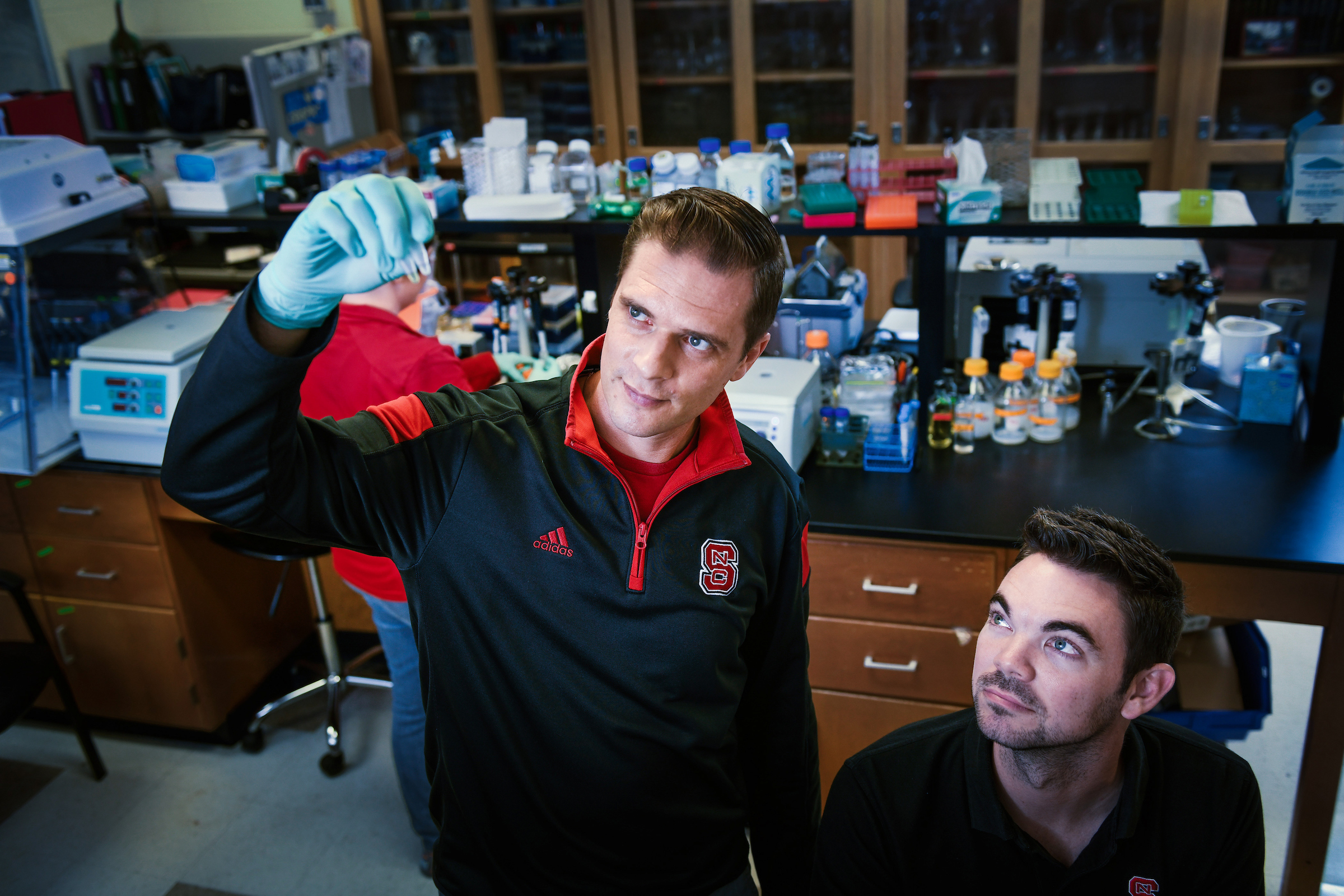 Researcher holding up flask in lab