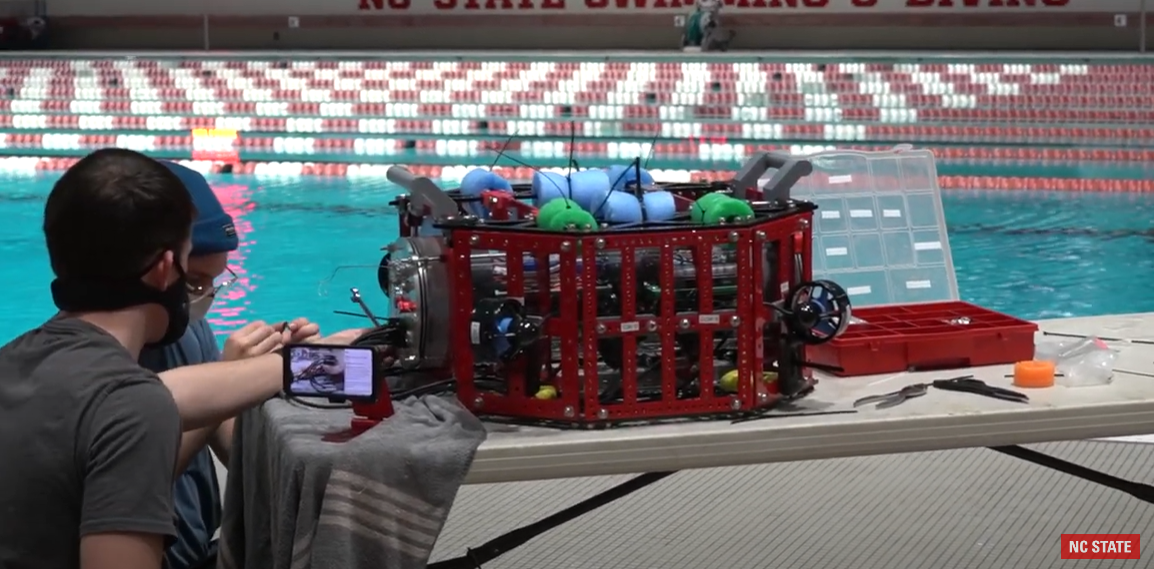 Students test a robot at the pool
