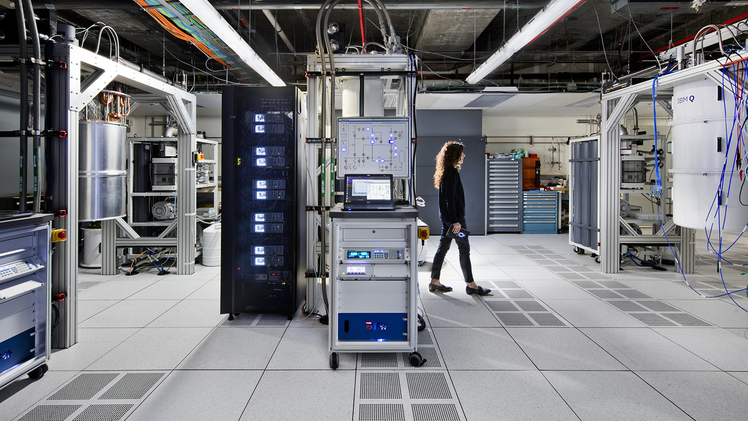 A woman walks across the floor inside IBM's quantum computer.