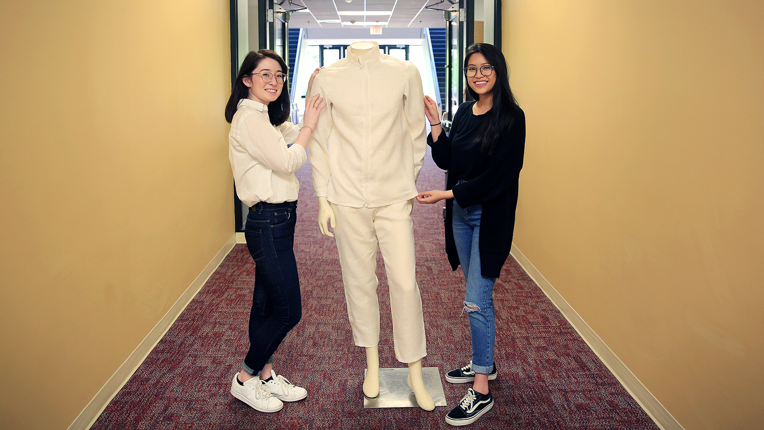 College of Textiles students Ashley Maurice and Ngoc Nguyen display mannequin wearing Protegete, a line of protective clothing for migrant workers in tobacco fields