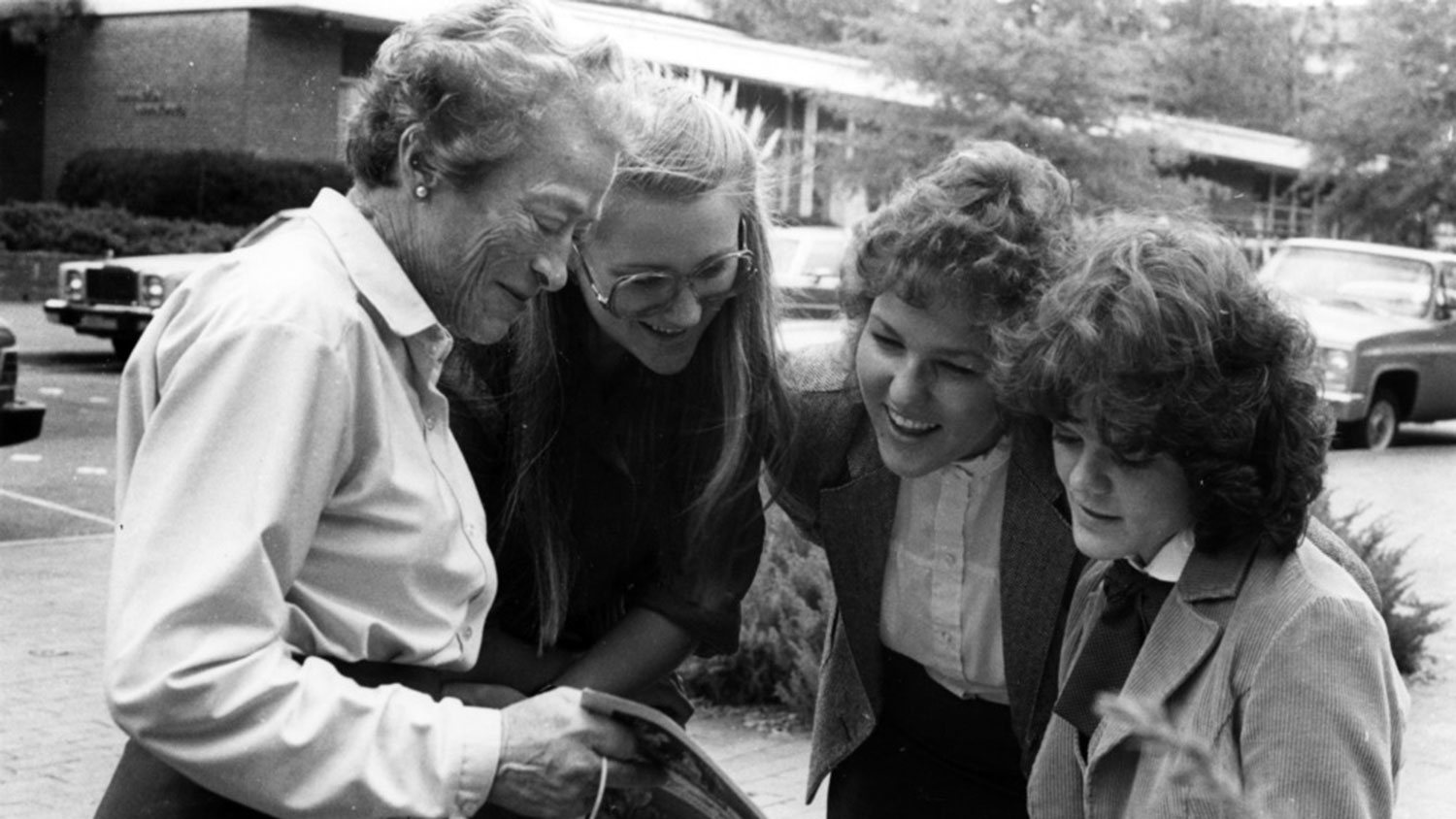 Katherine Stinson, the first female graduate of the College of Engineering, with students on campus (circa 1970s).