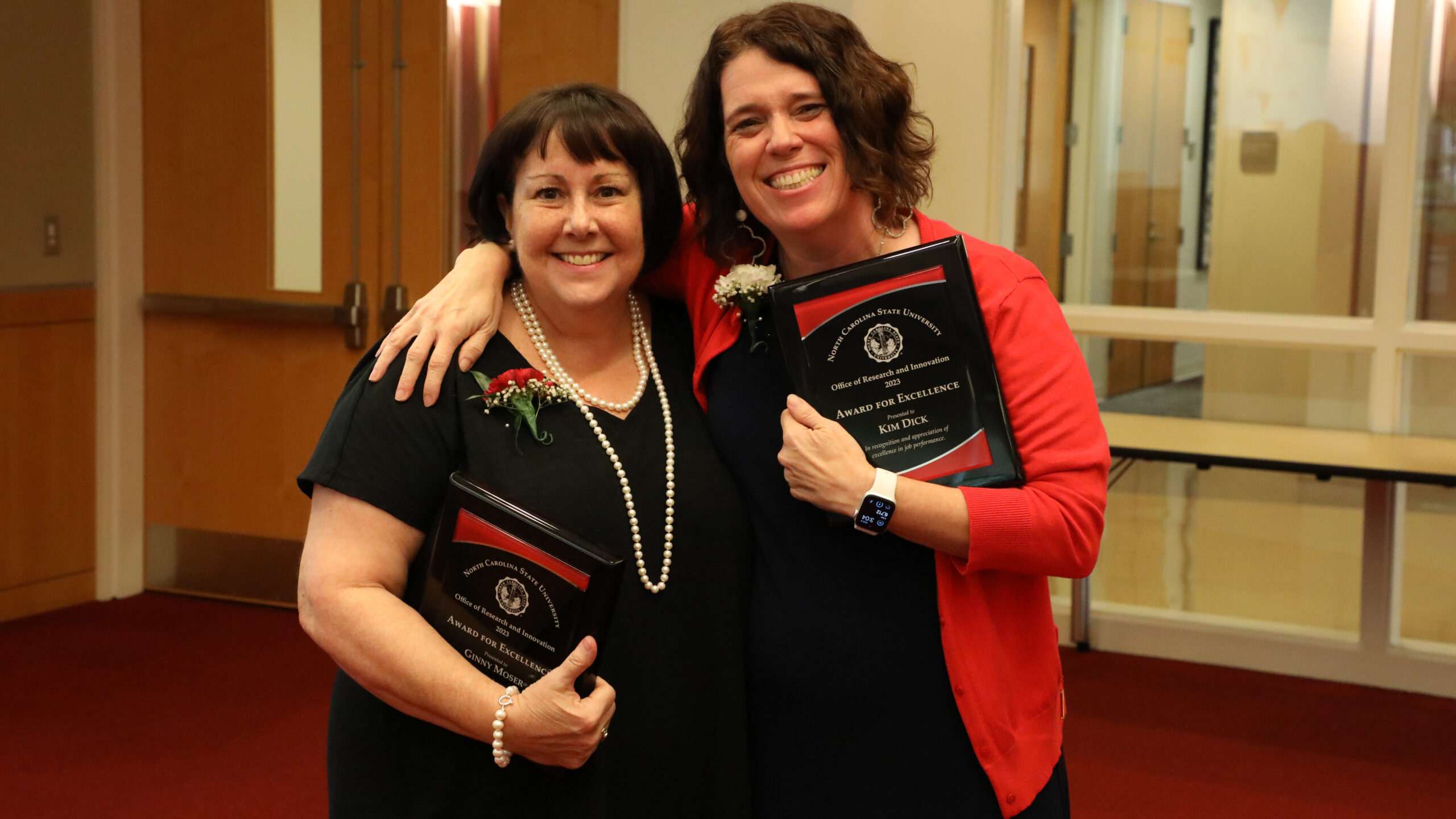 Ginny Moser and Kim Dick pose with the plaques they received as winners of ORI's 2023 Award for Excellence.
