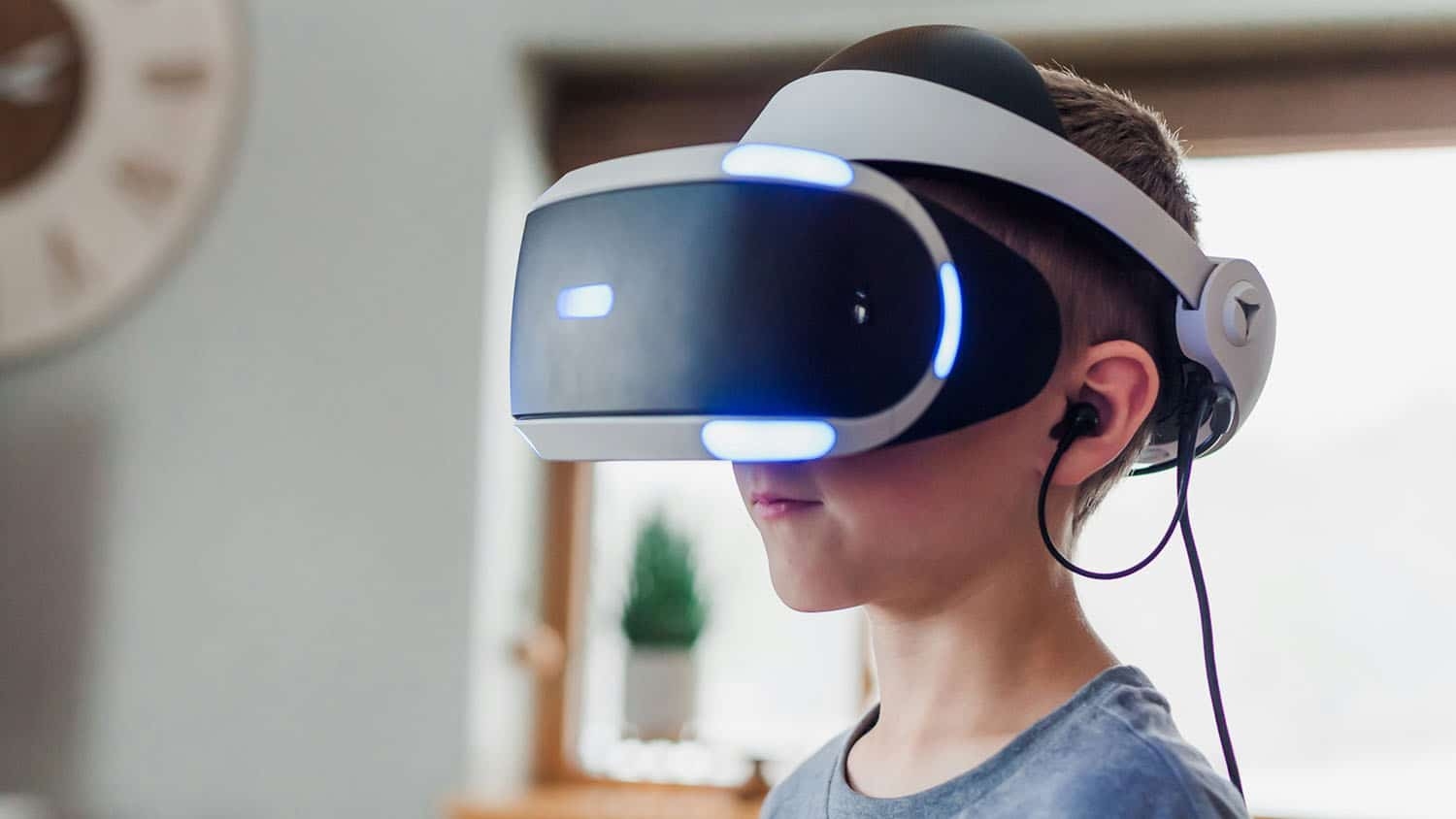 photo shows a gradeschool-aged boy wearing a virtual reality headset