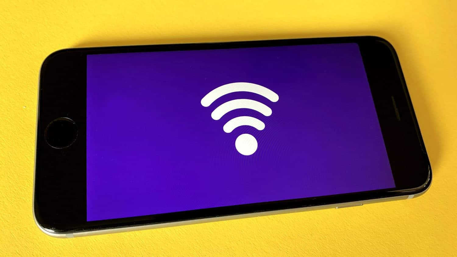 a smartphone displays the wi-fi symbol on its screen