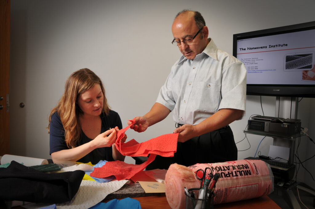 Genevieve Garland and Behnam Pourdeyhimi look over samples.
